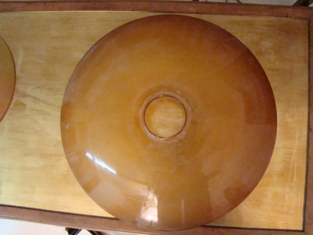 Top view of 2 antique hanging lamps, featuring unique details.