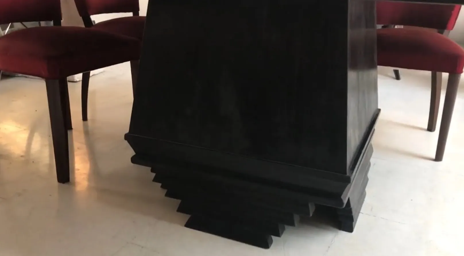 Antiker Esstisch im Art Deco Design für 8 Personen, umgeben von roten Stühlen in einer gemütlichen Umgebung.