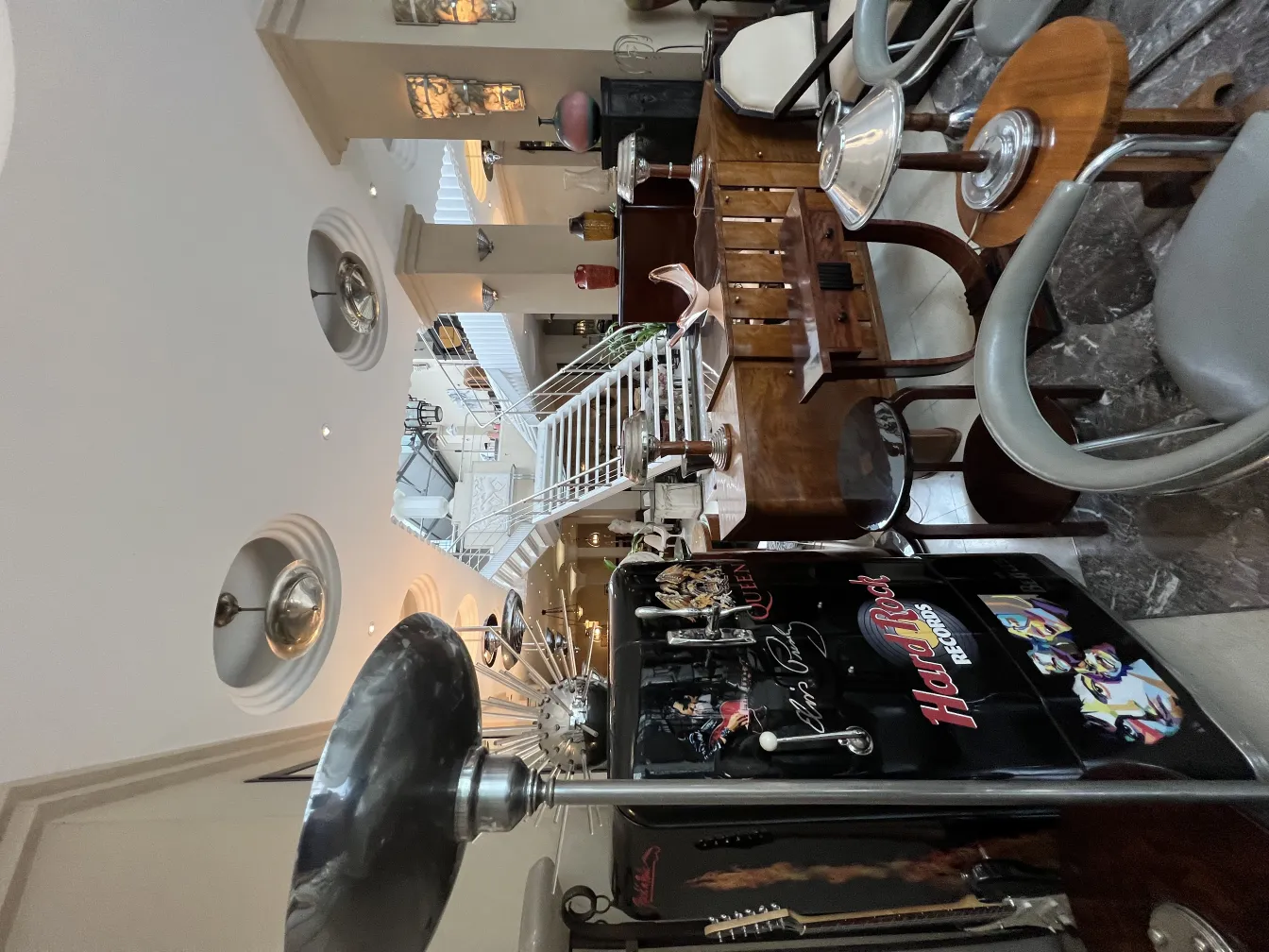 View of 2 antique hanging lamps in an elegant decorative setting with various furniture