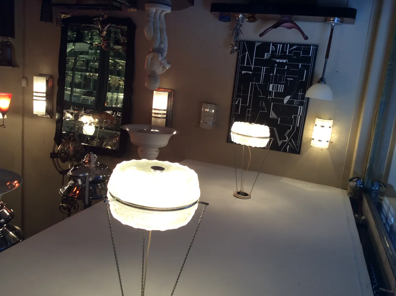 Two antique hanging lamps illuminating a room.