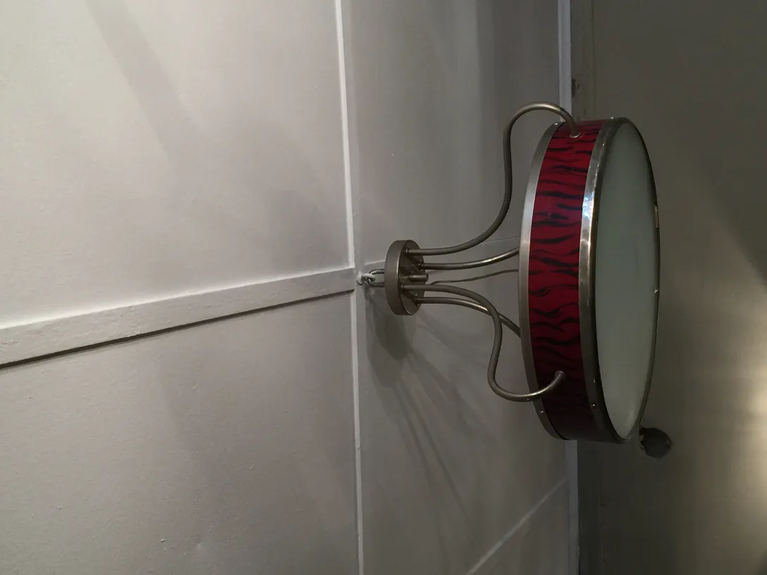 Side view of two antique hanging lamps with a colorful and vibrant design, mounted on the wall.