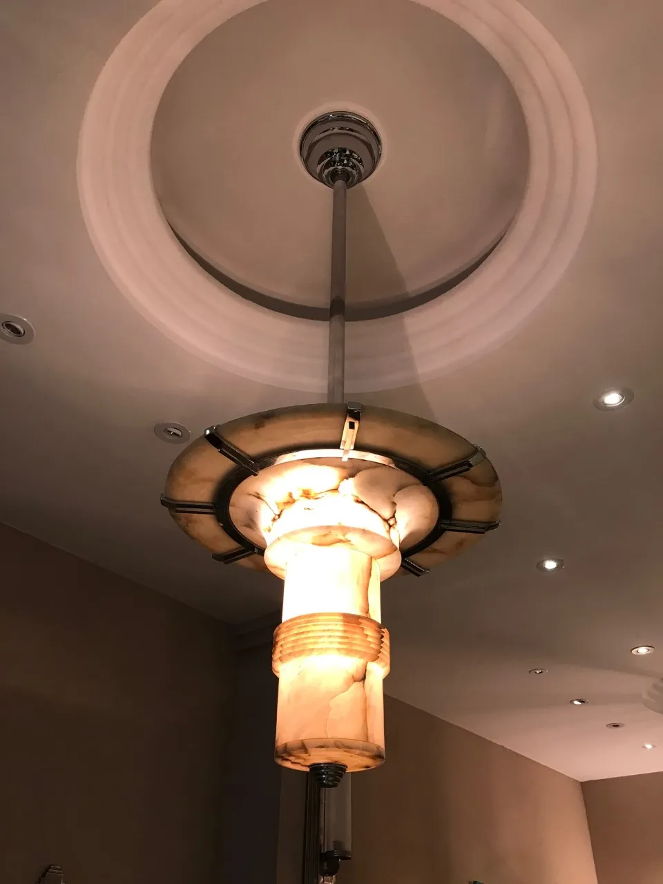 two antique hanging lamps with elegant design in room.