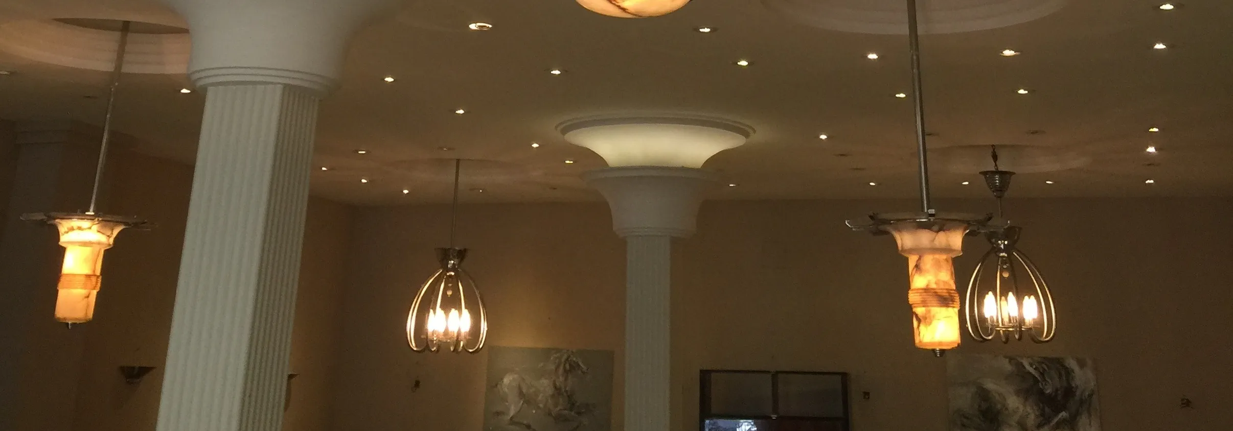 Two antique hanging lamps with elegant design in a well-lit space