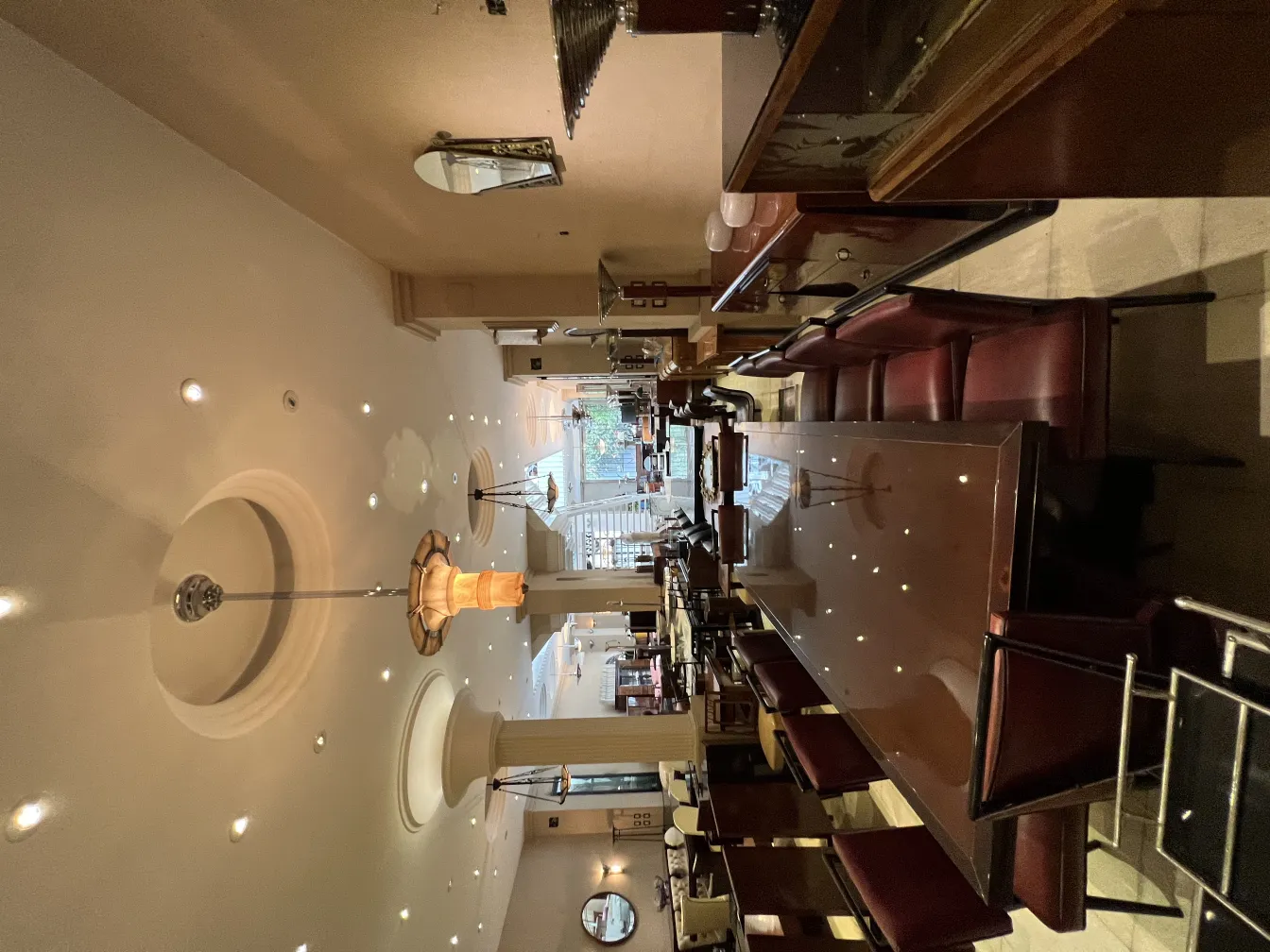 View of two antique hanging lamps in an elegant restaurant setting.
