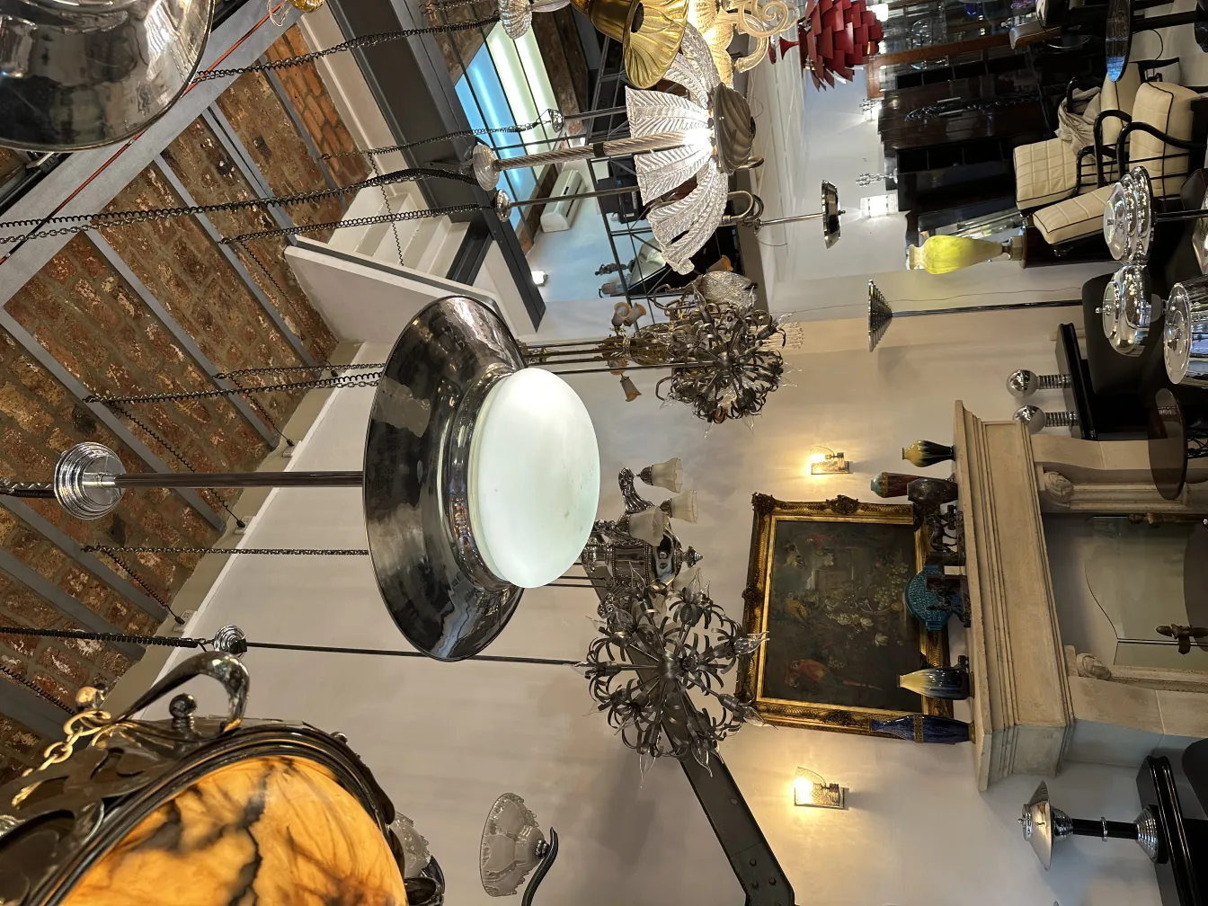 view of 2 elegant hanging lamps in an antique store