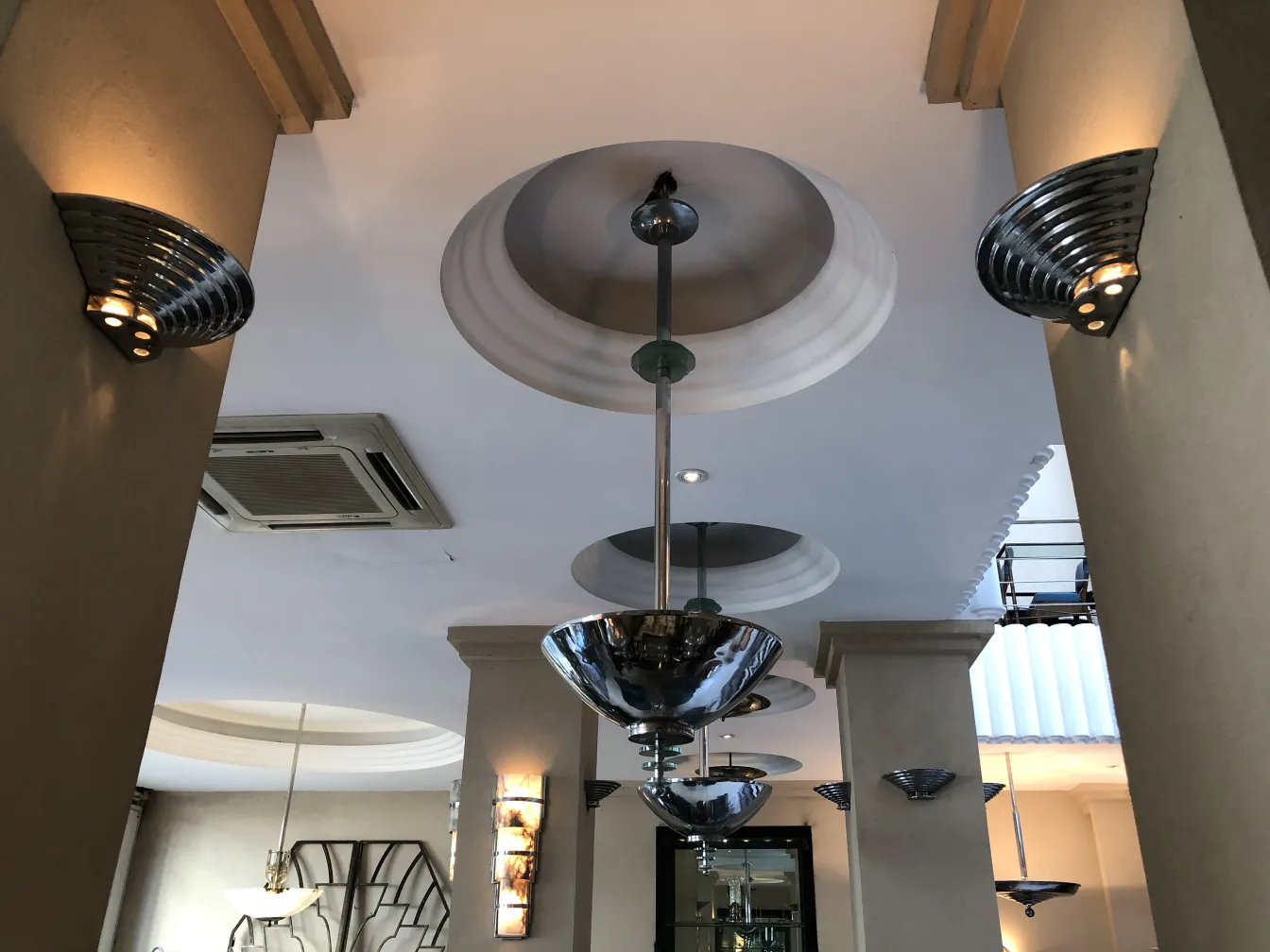 View of 2 antique hanging lamps with soft lights in an elegant fixture, in a modern setting