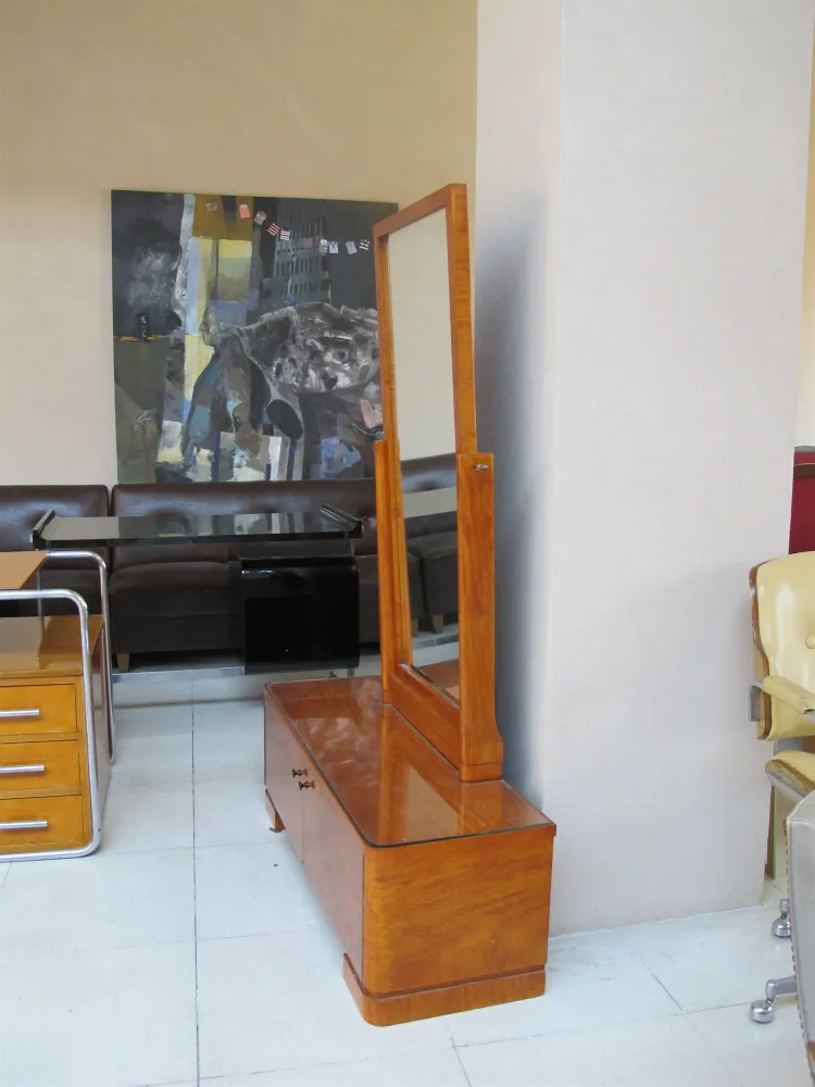 Antique vertical mirror with a stand in a modern setting.