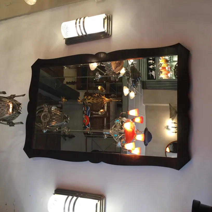 antique mirror with decorative frame and light fixtures around