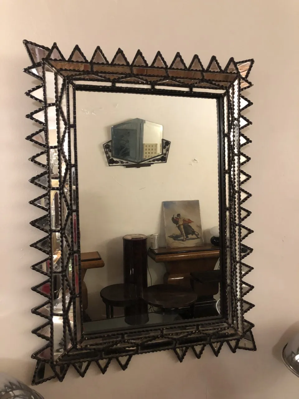antique mirror with a decorative frame on a wall