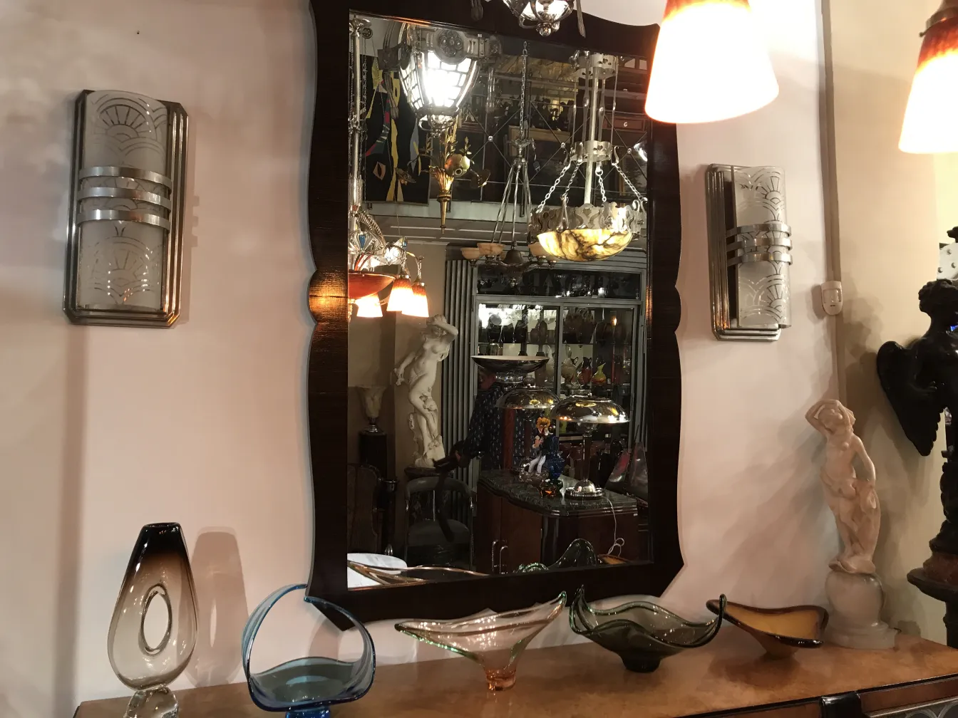 decorative antique mirror with elegant frame, surrounding antiques