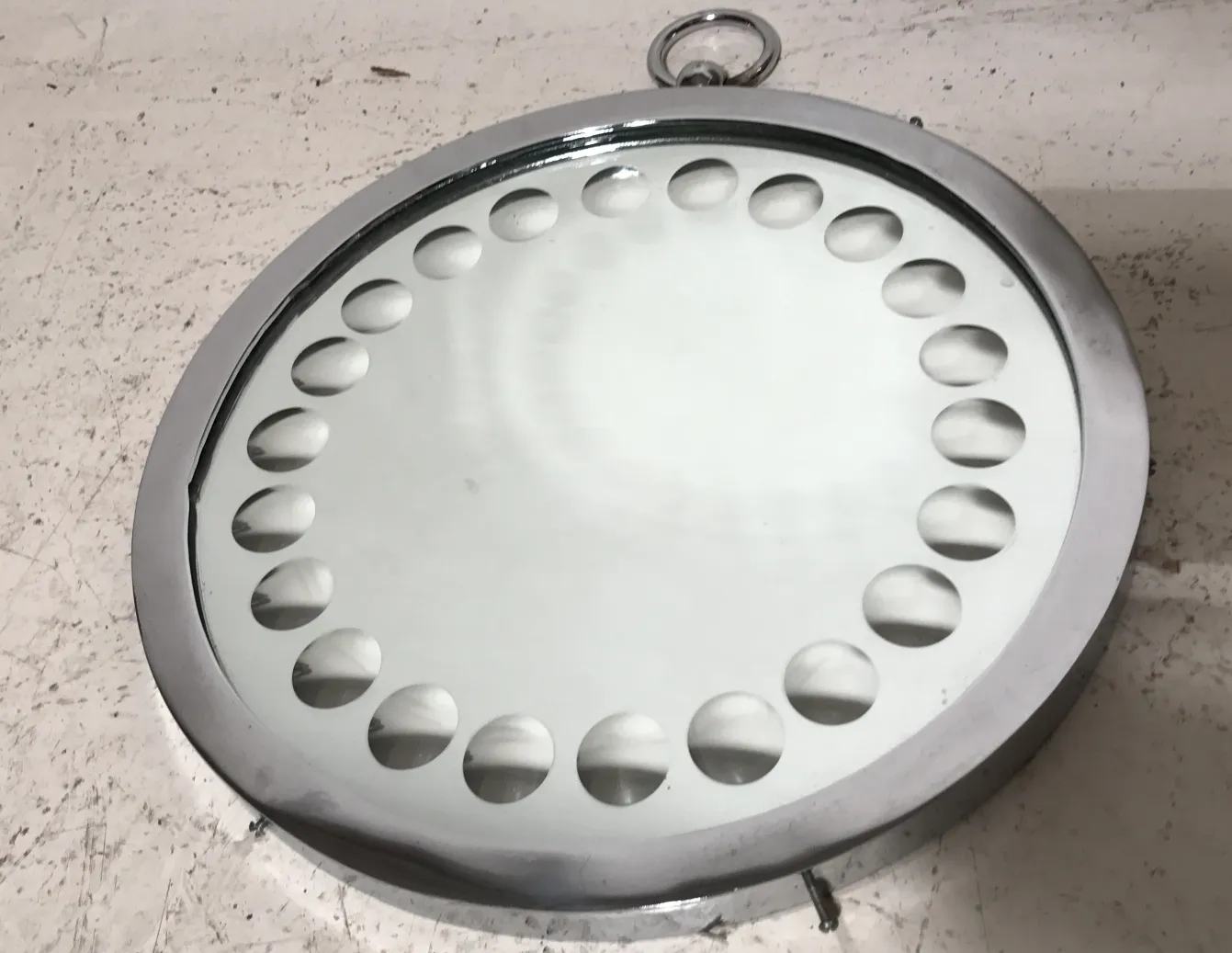 Antique mirror with rounded frame details on neutral background