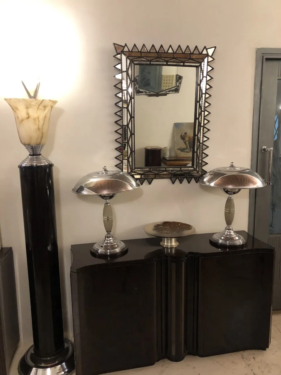 Antique decorative mirror with a stylish frame in a classic setting.