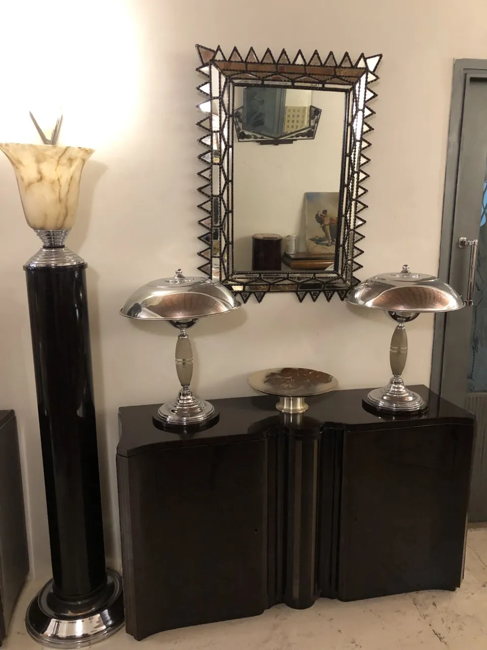 decorative antique mirror with intricately carved frame in an elegant setting.