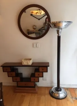 antique round mirror with an elegant frame on the wall