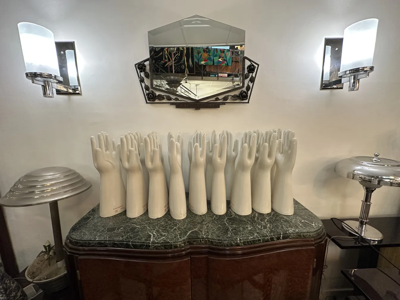 antique mirror on the wall with lighting fixtures