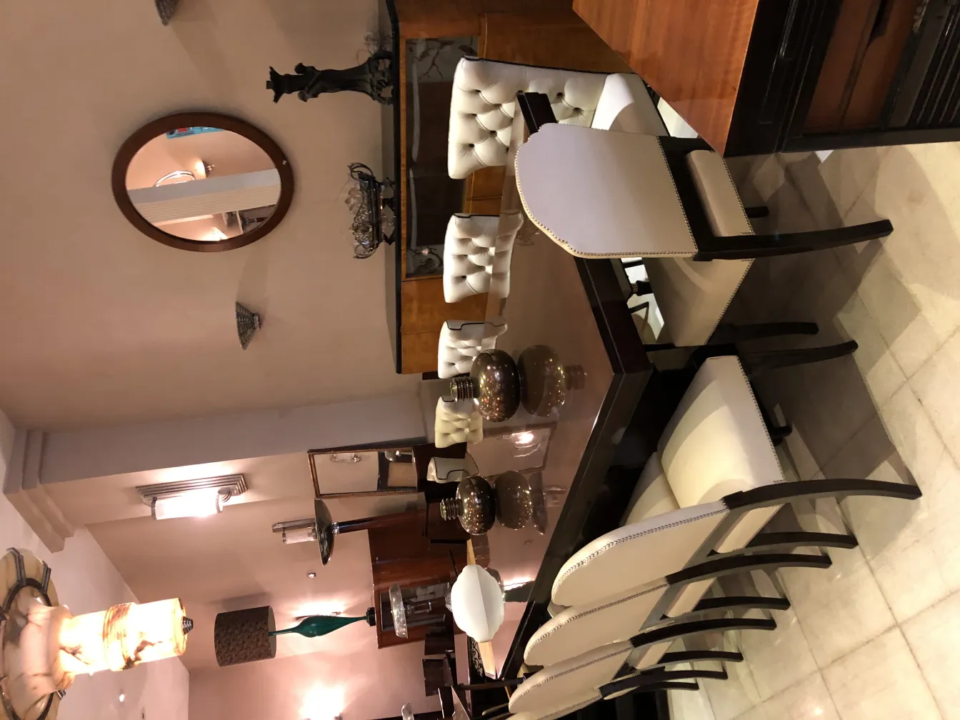 antique round mirror on the wall with elegant furniture