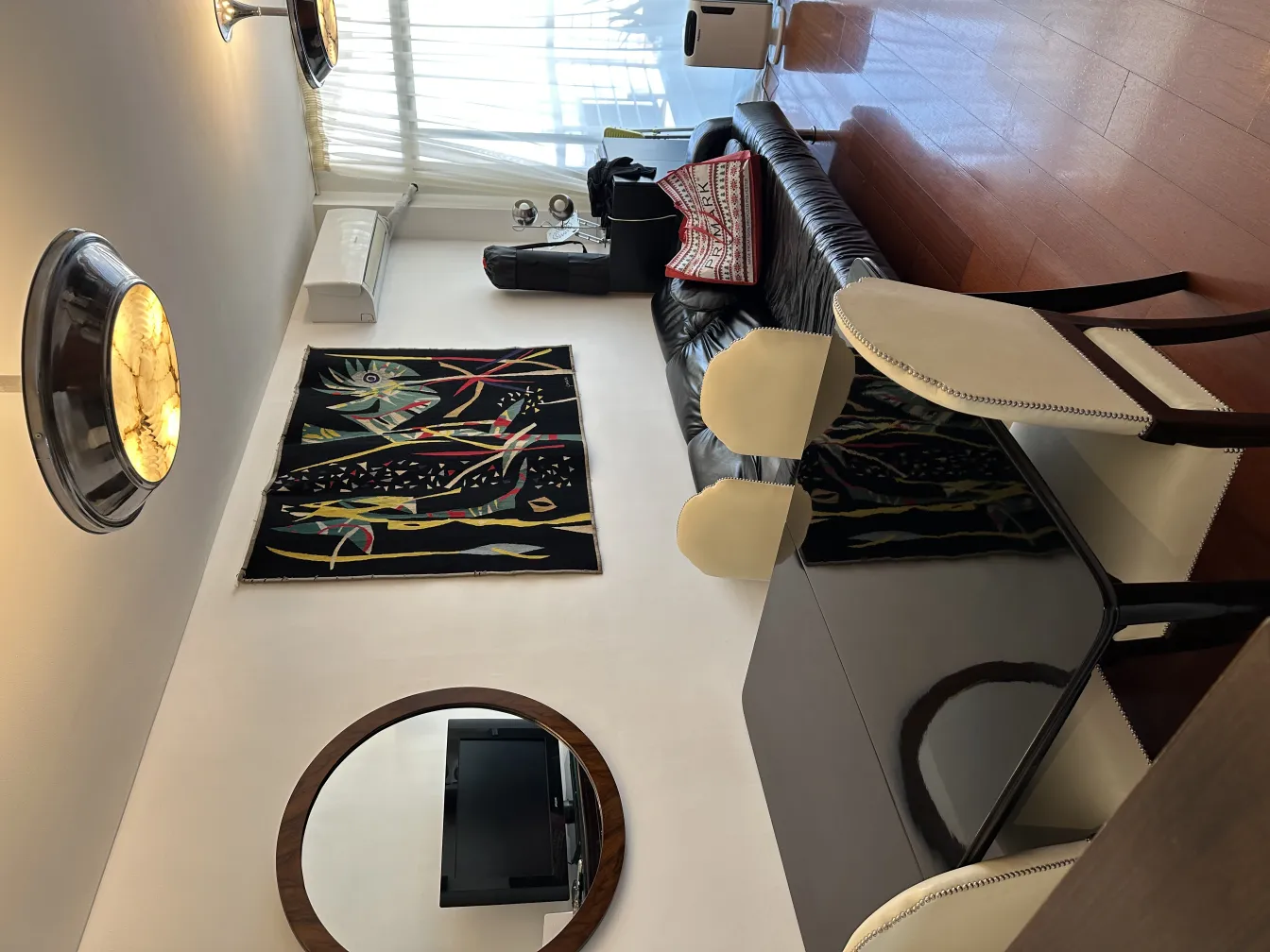 antique round mirror in modern interior with art