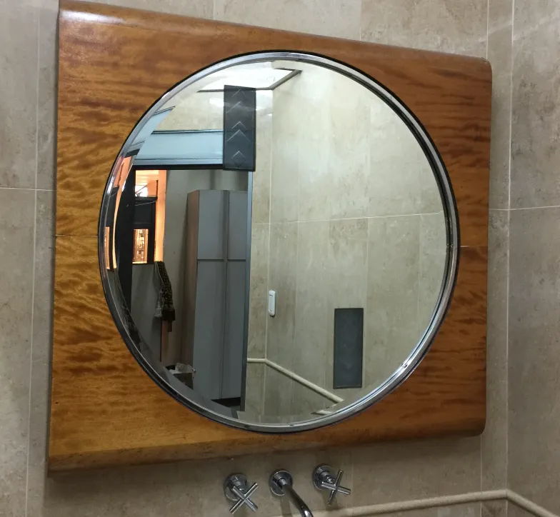 antique round mirror with frame in a bathroom
