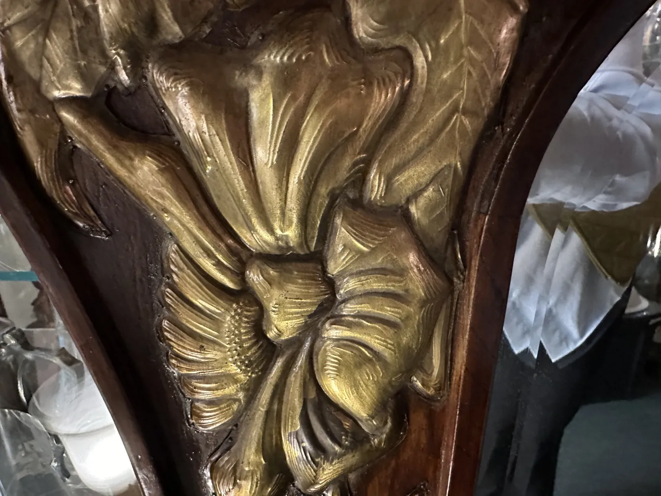 antique mirror adorned with gold details, elegant setting