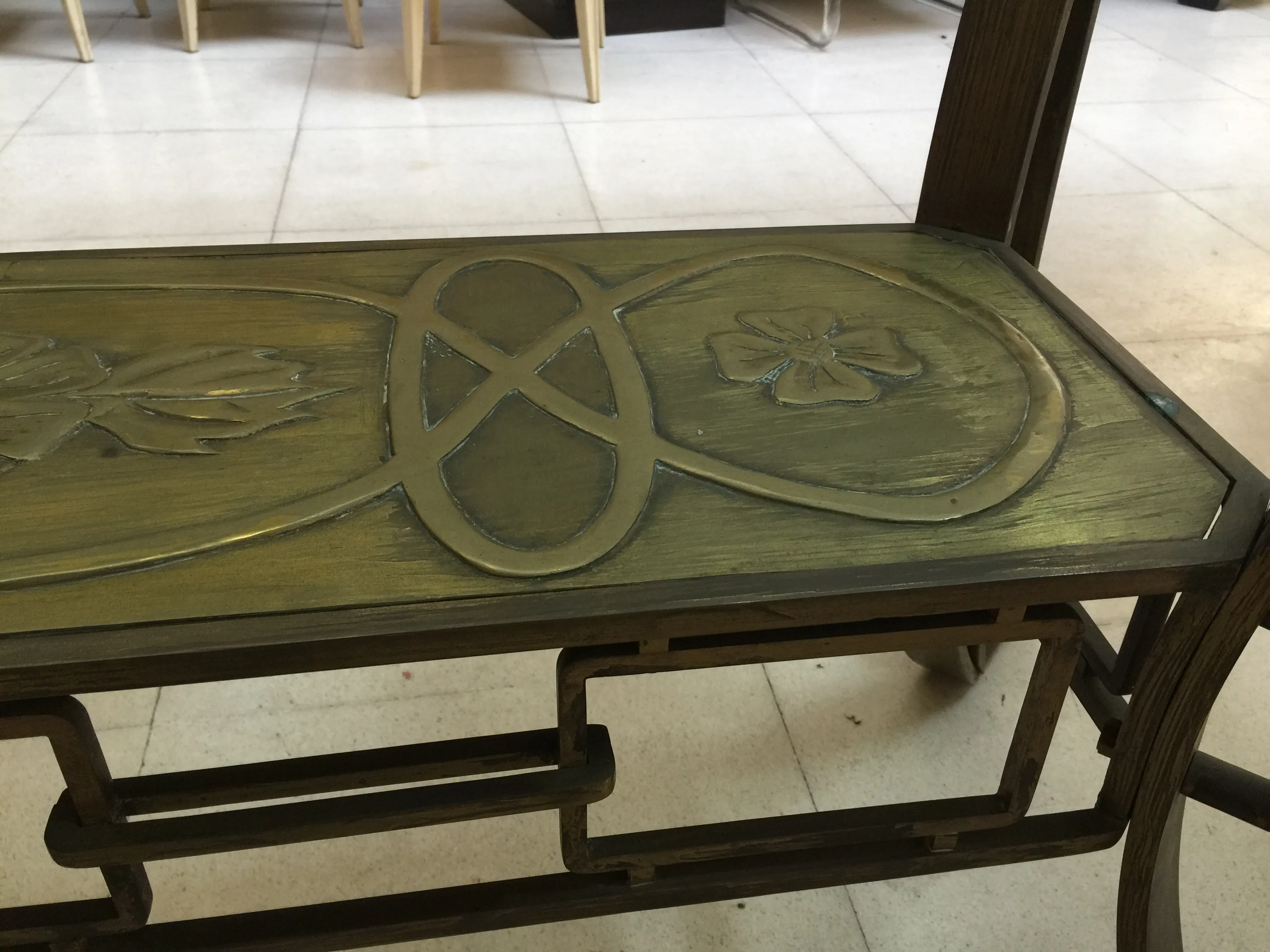 Antique dining table for 10, featuring decorative engravings.