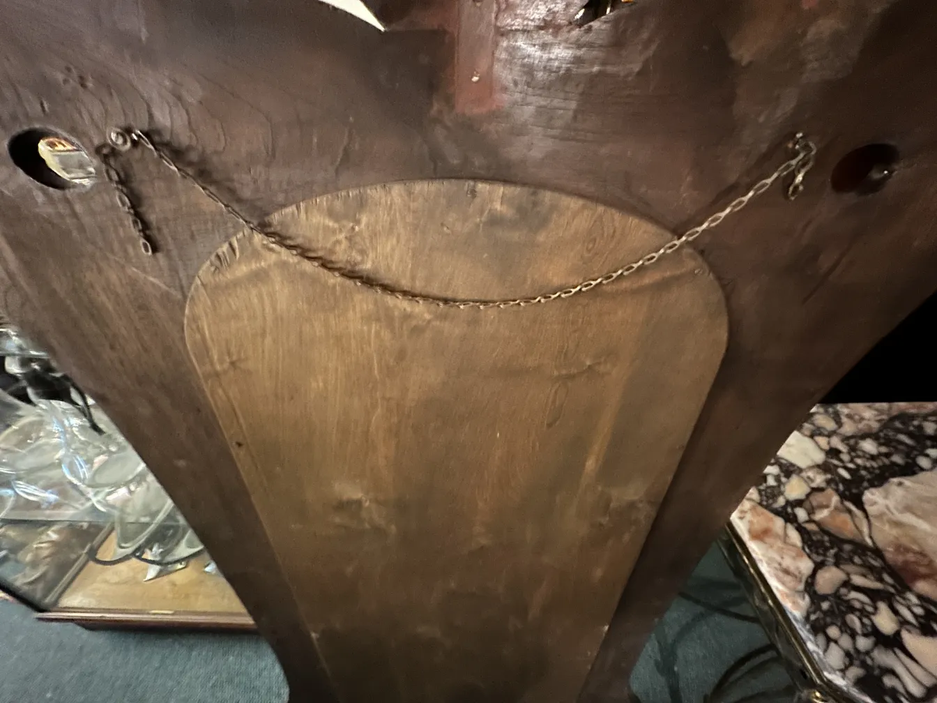 antique mirror with chain, dark background and wood