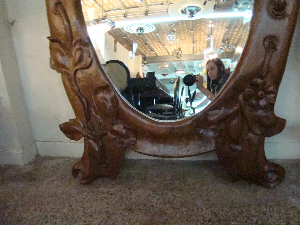 antique mirror with decorative frame, in a softly lit environment