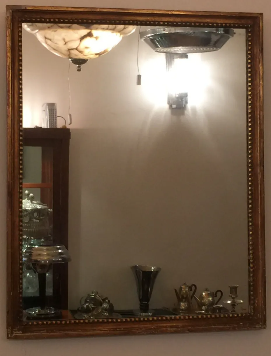 antique wall mirror with gold frame, soft lighting and vintage decor.