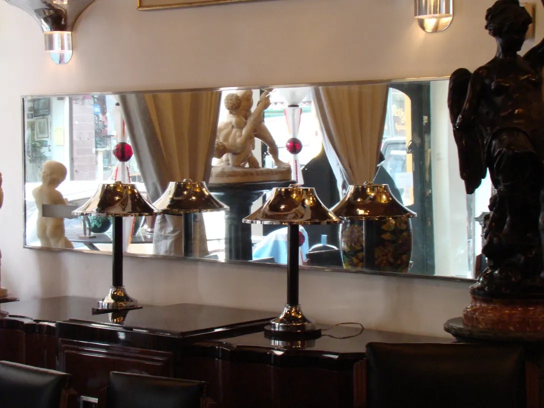 antique wall mirror in an elegant setting with lamps