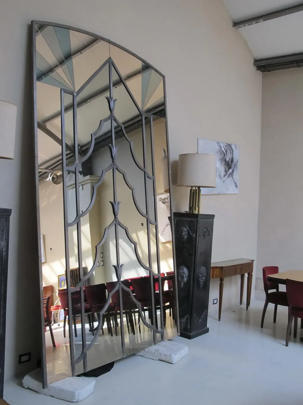 Antique mirror with an elegant decorative design in a modern setting.