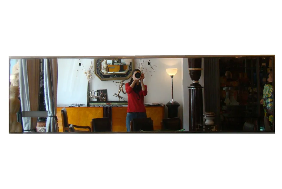 antique wall mirror displaying clear reflection in room