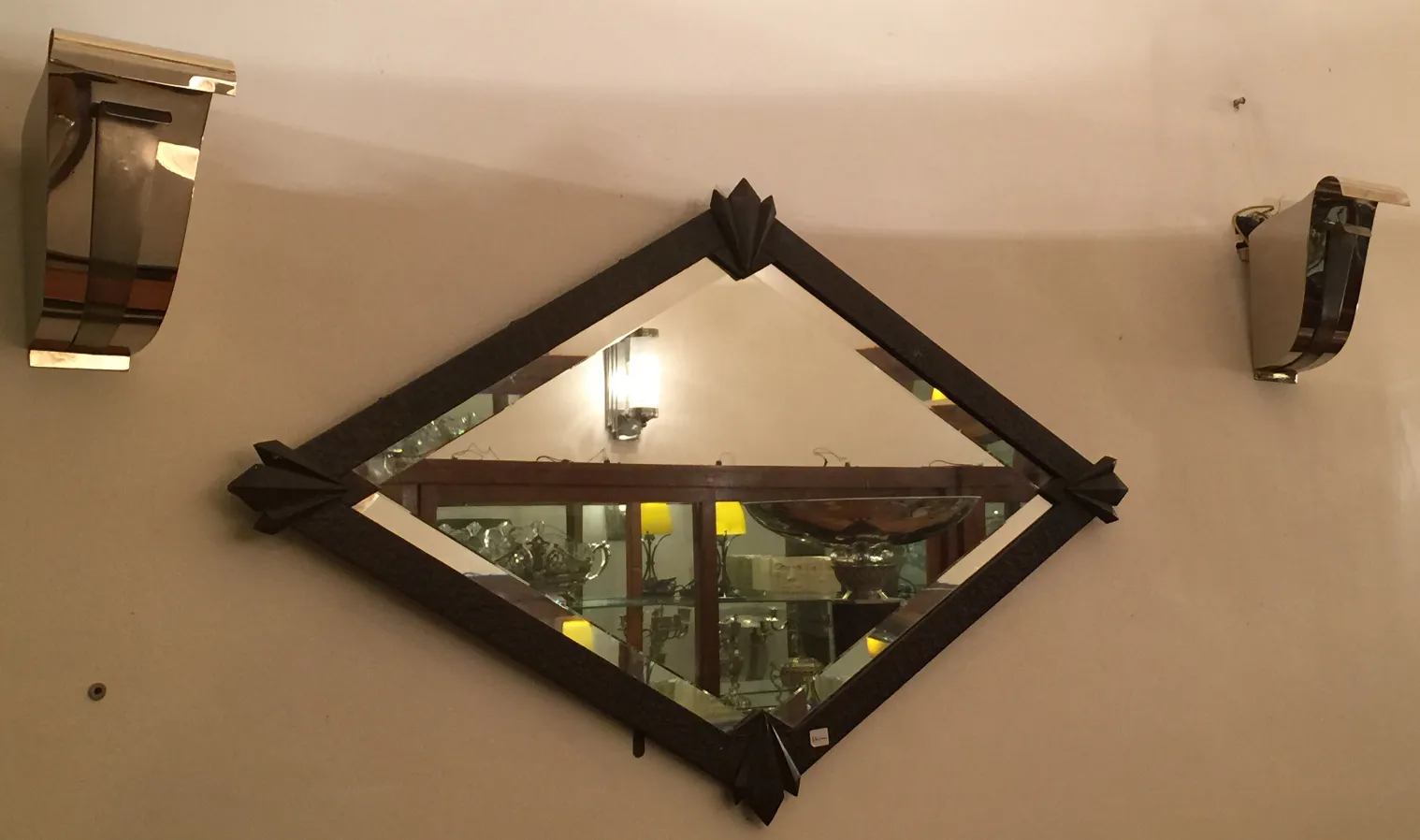 antique rhombus-shaped mirror with wall frame