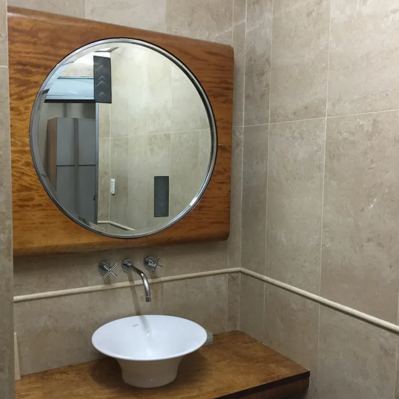 antique round mirror with bevel on a light wall