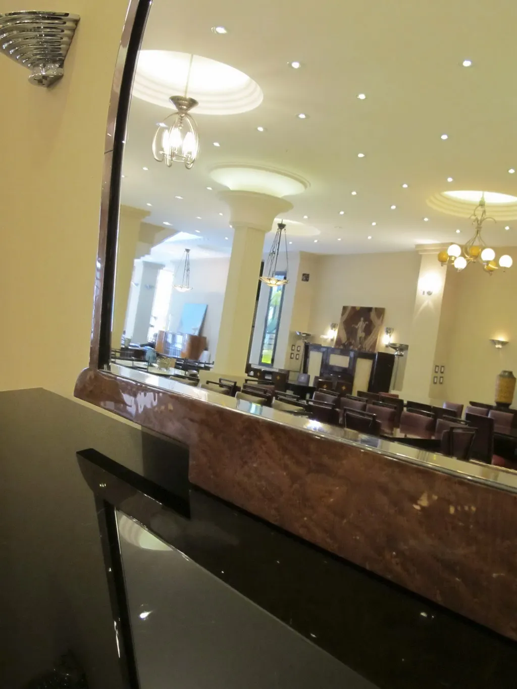 antique mirror reflecting an elegant interior with lights