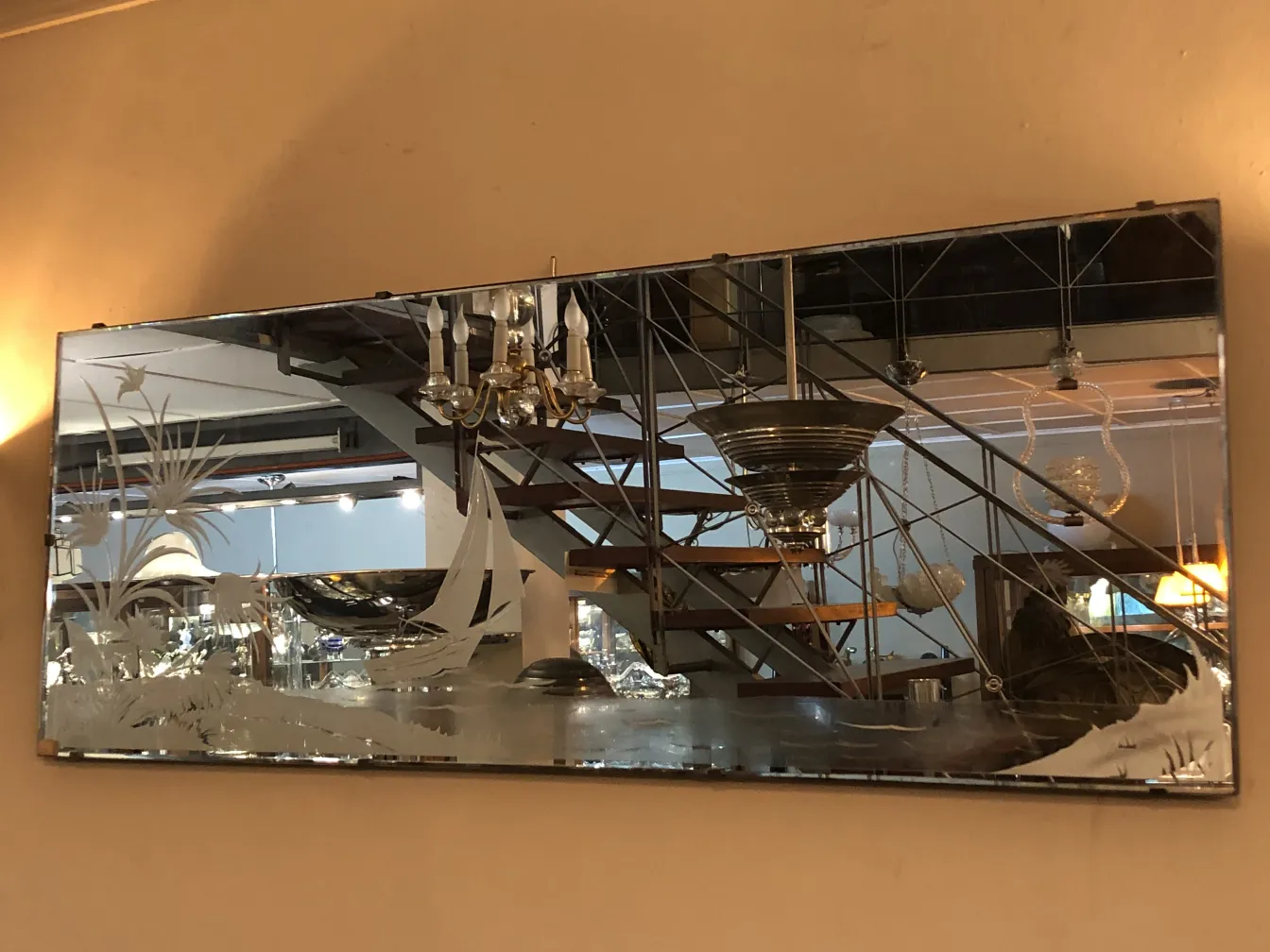 antique mirror featuring landscape engravings in a bright setting