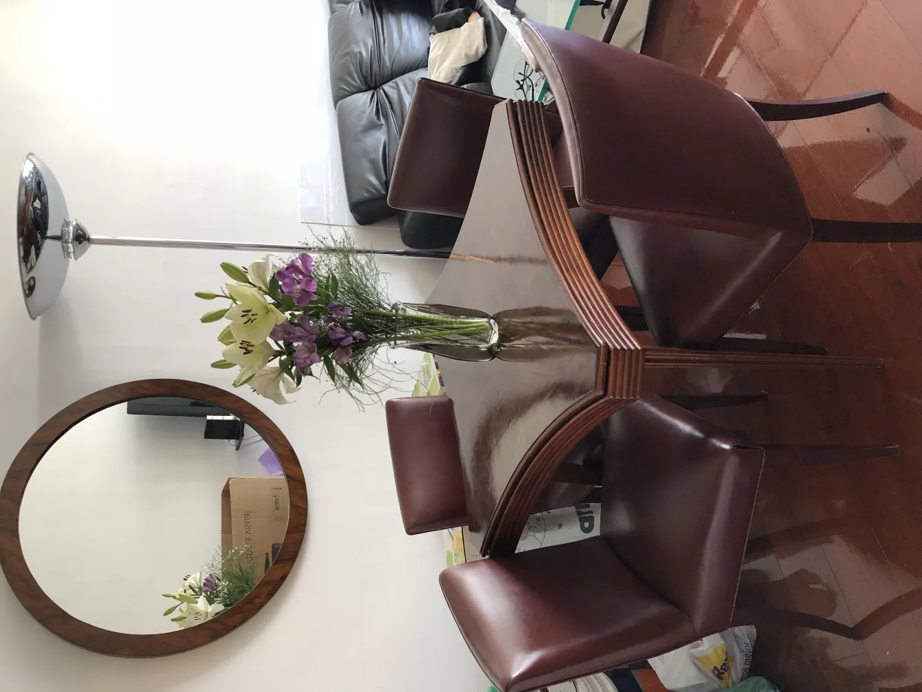 antique oval mirror in a cozy setting with flowers