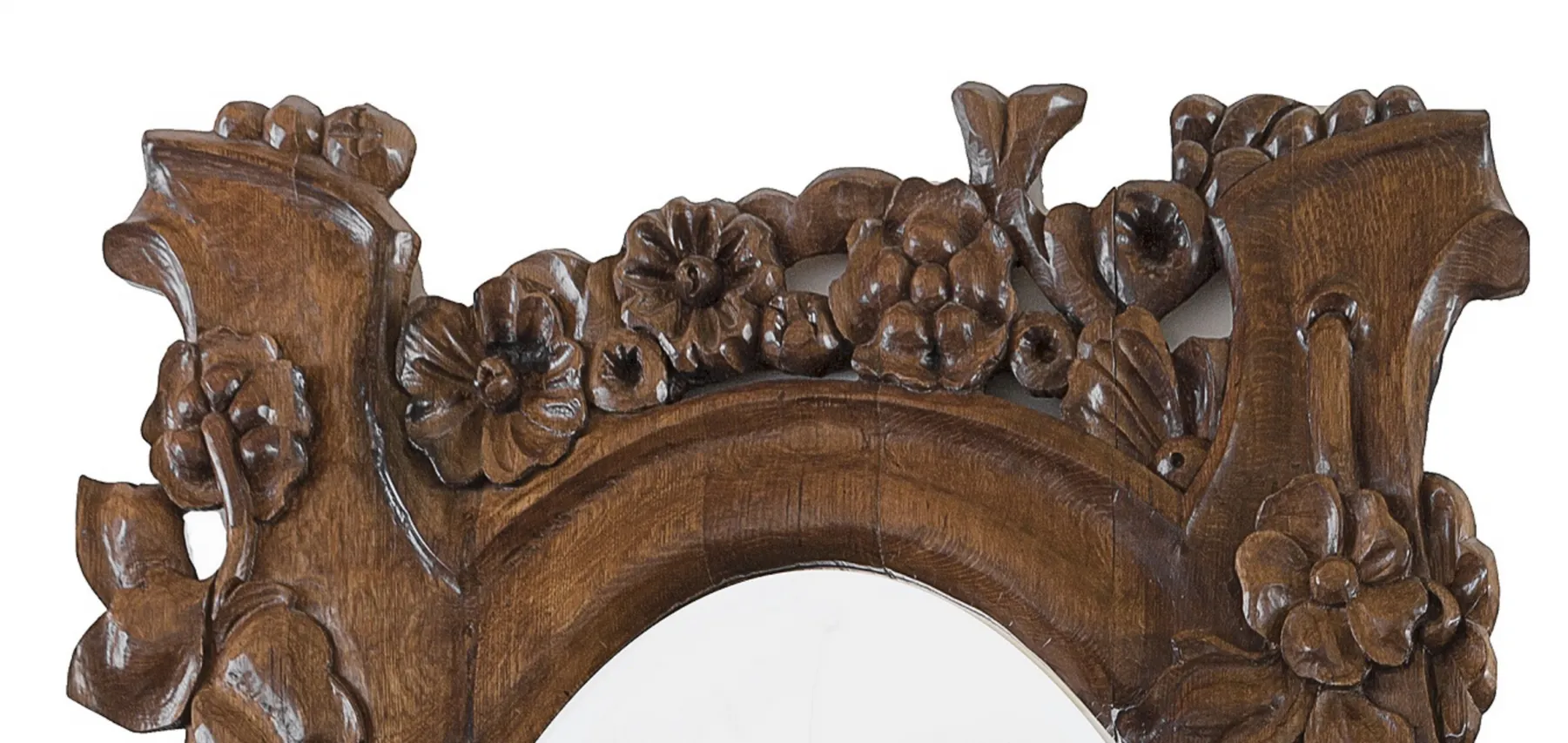 antique mirror featuring an ornate floral carved frame