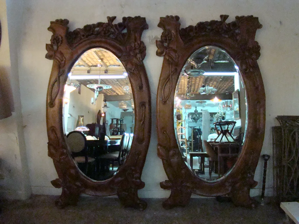 Antique decorative mirror with an oval shape and ornate frame
