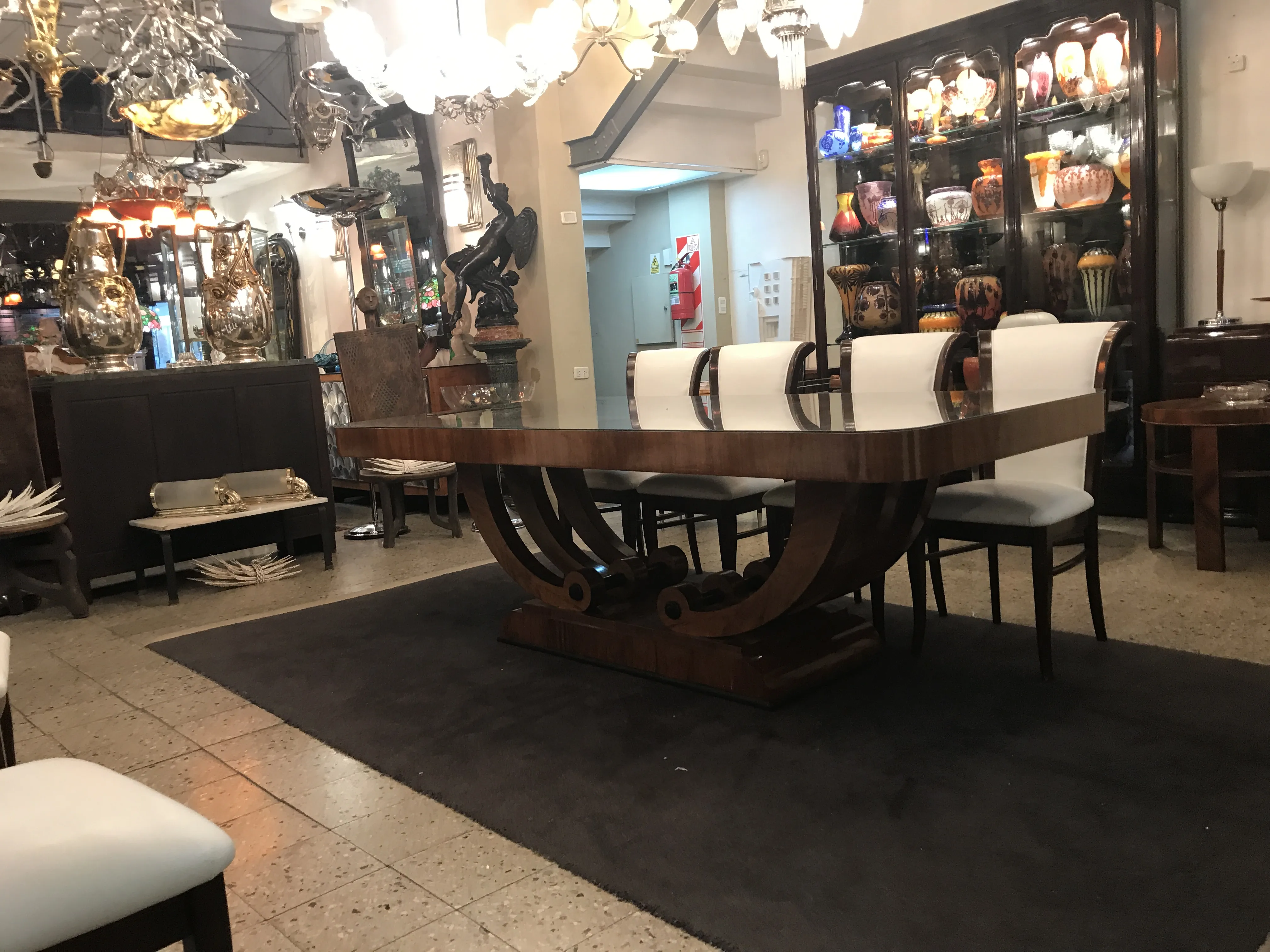 Antique dining table for 10 people in an elegant setting.