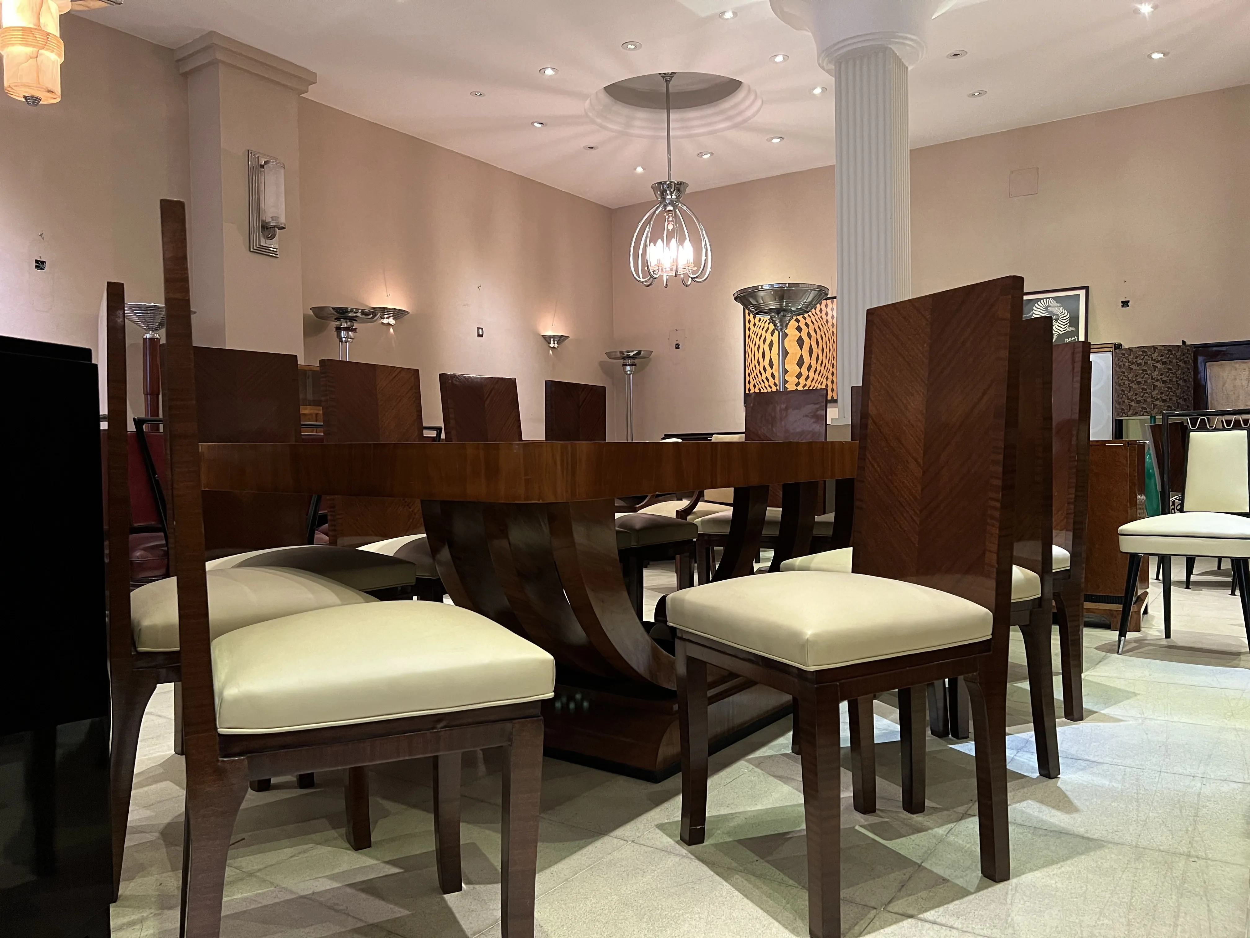 Antique dining table for 10 people with chairs. Elegant setting.