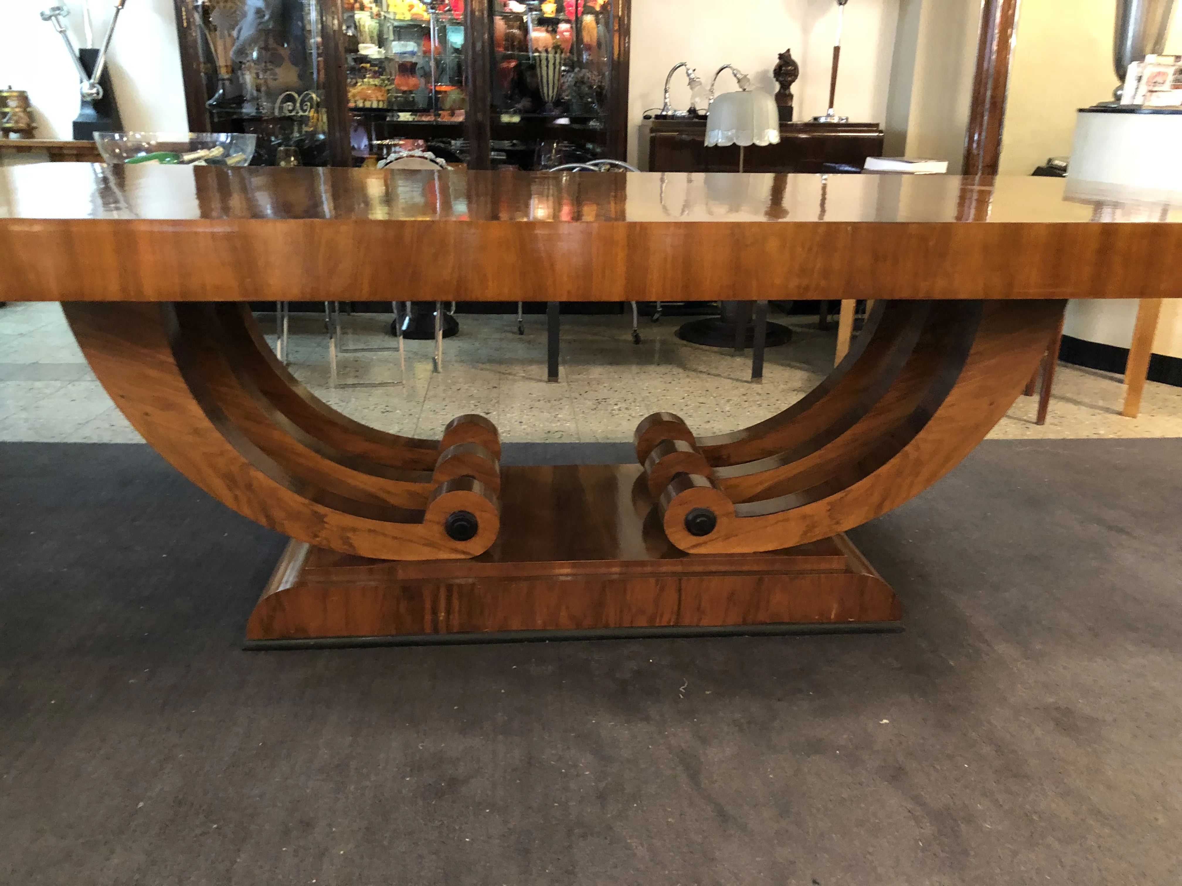 Antique Art Deco dining table for 10 people, featuring decorative legs.