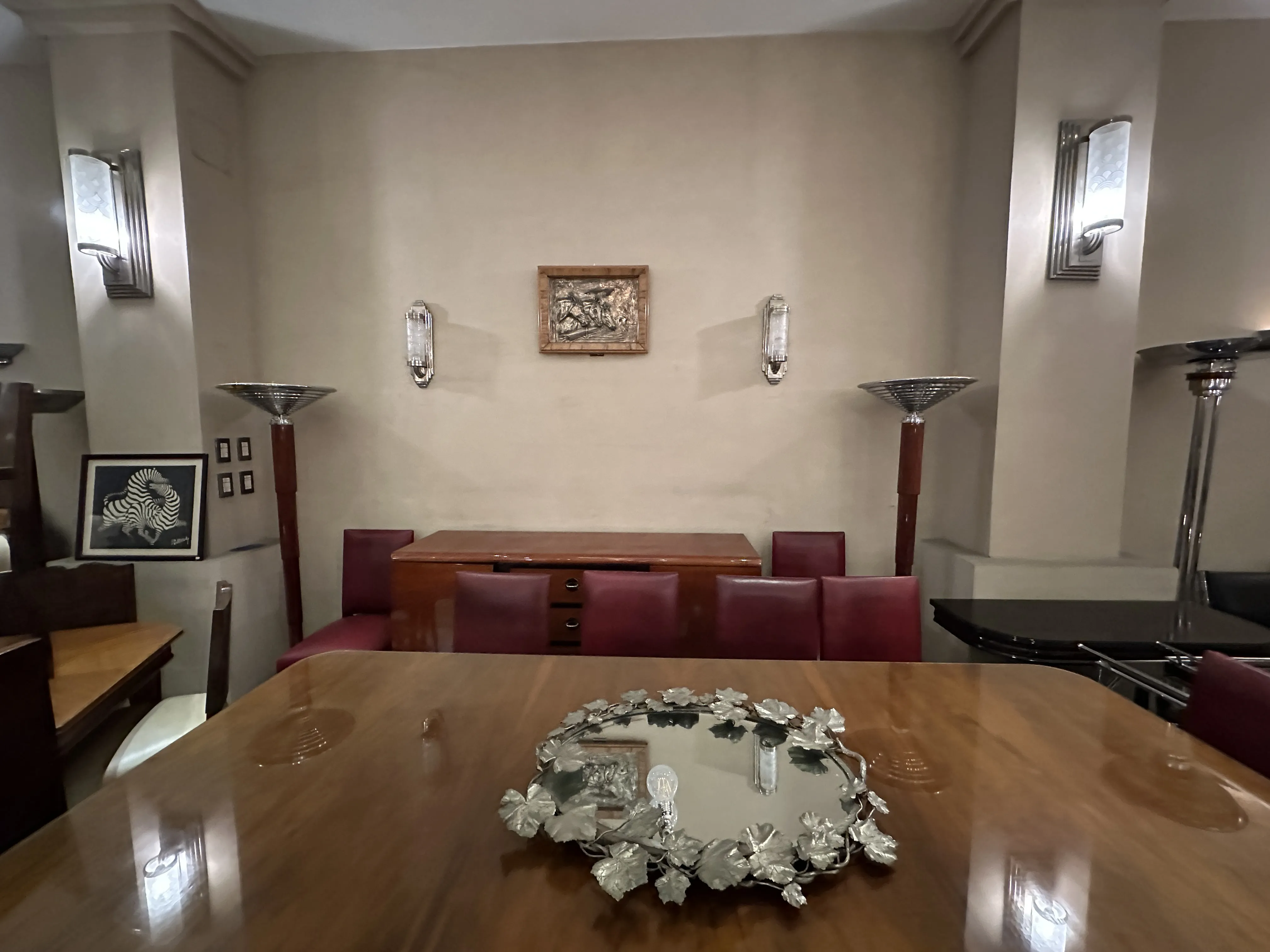 Antique dining table for 10 people in an elegant setting.