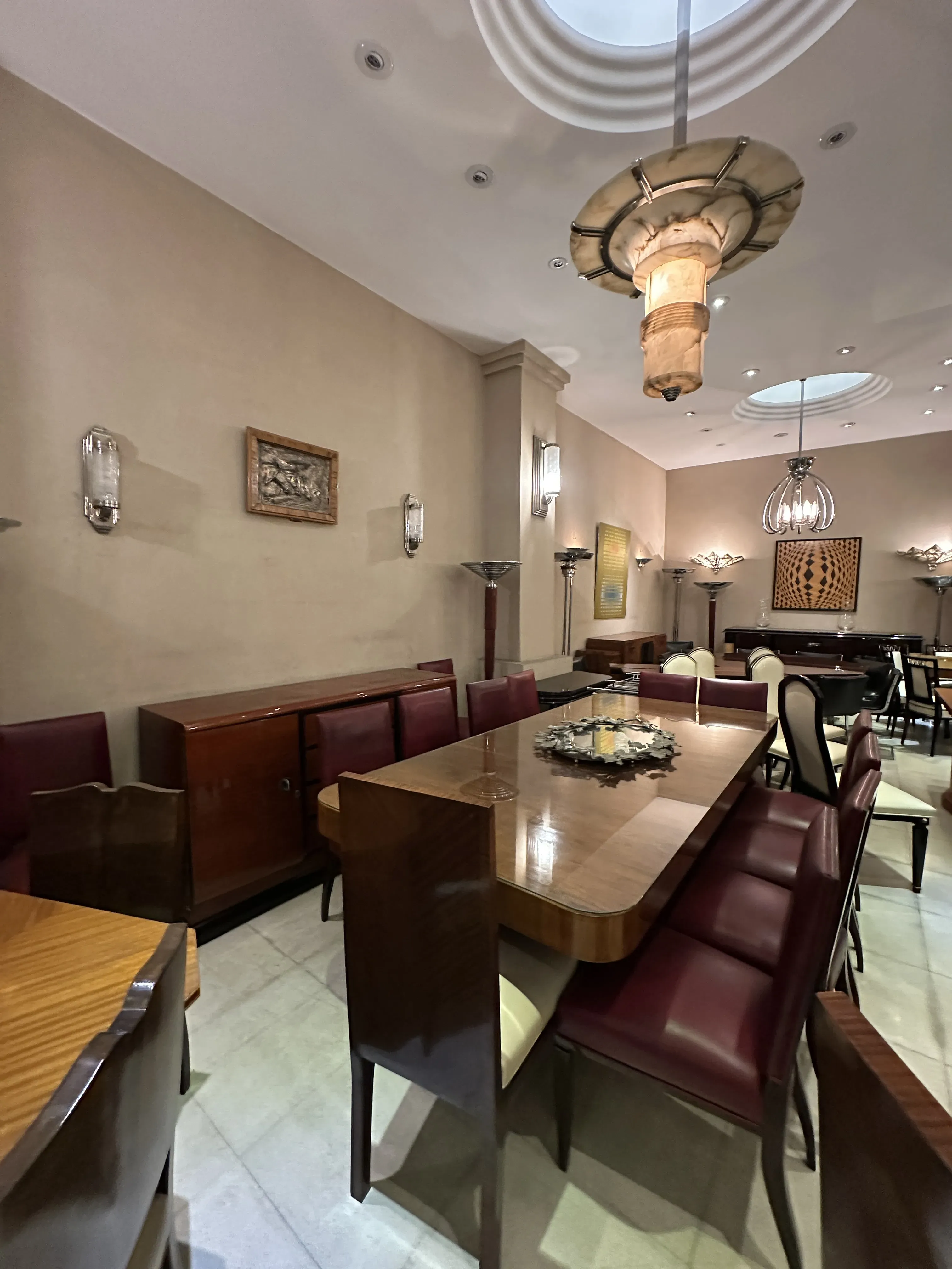 Antique dining table for 10 people with elegant chairs in a cozy setting.