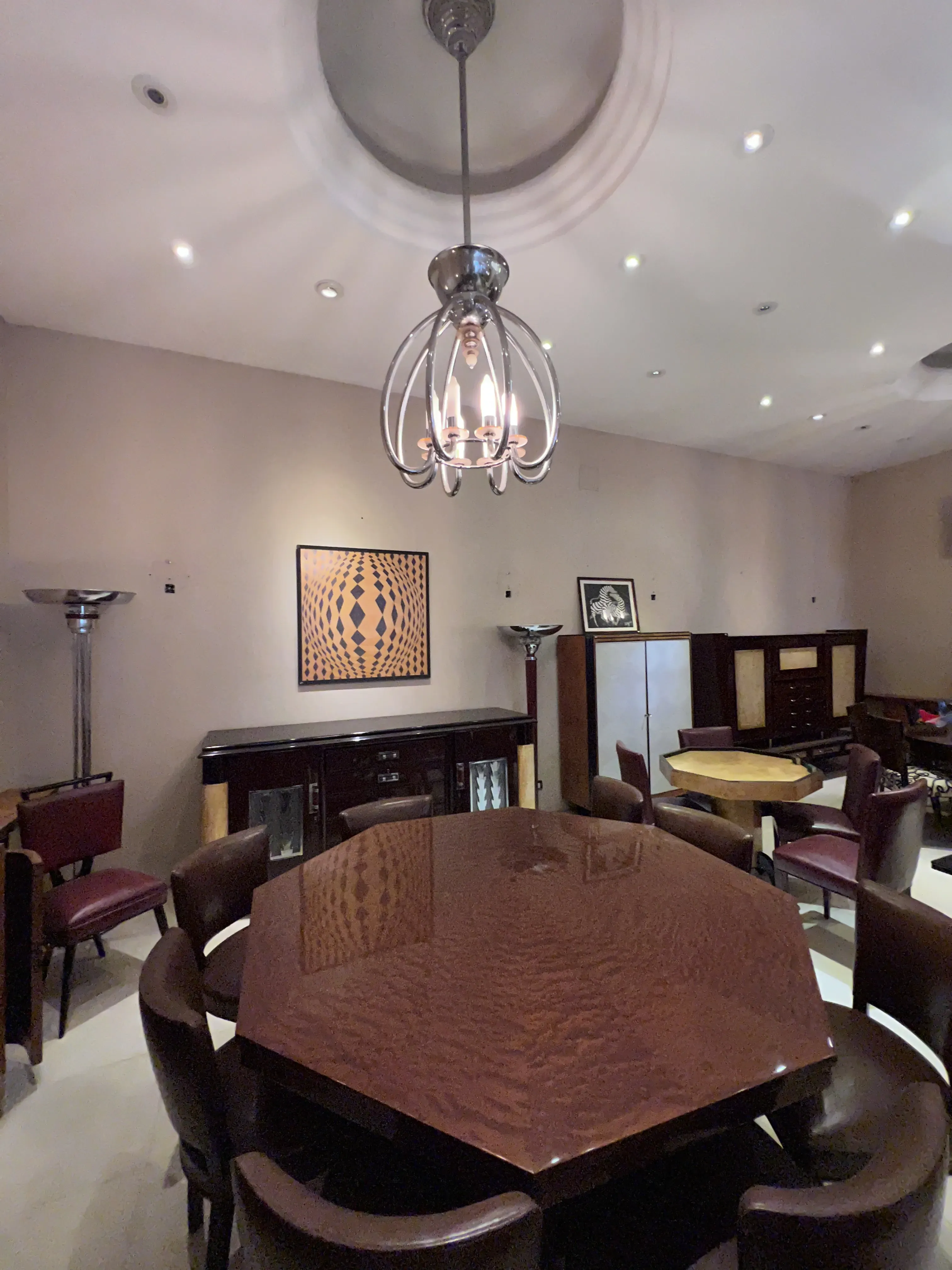 Antique octagonal dining table with chairs, cozy atmosphere.