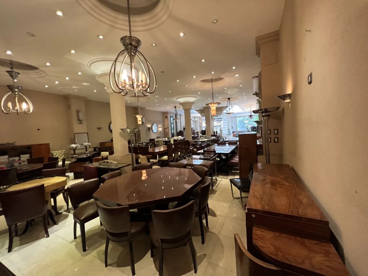 Antique dining table with chairs in an elegant setting.