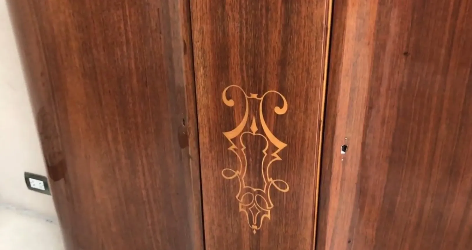 Details on the surface of the antique bookcase with decorative design.
