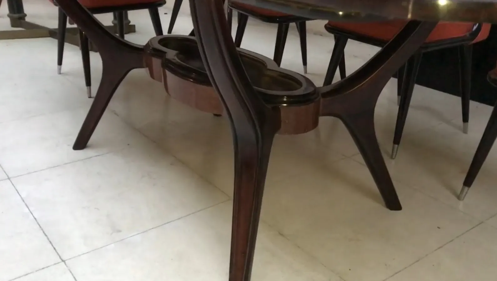 Antique dining table for eight people, featuring curved legs.