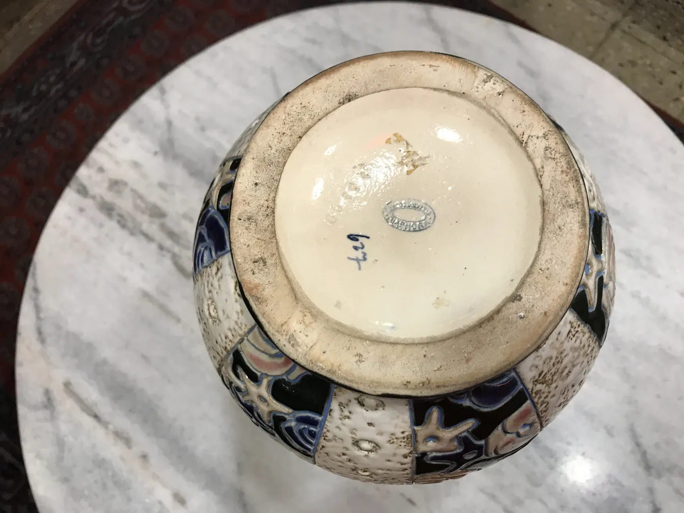 Top view of an antique decorative ceramic featuring colorful details.