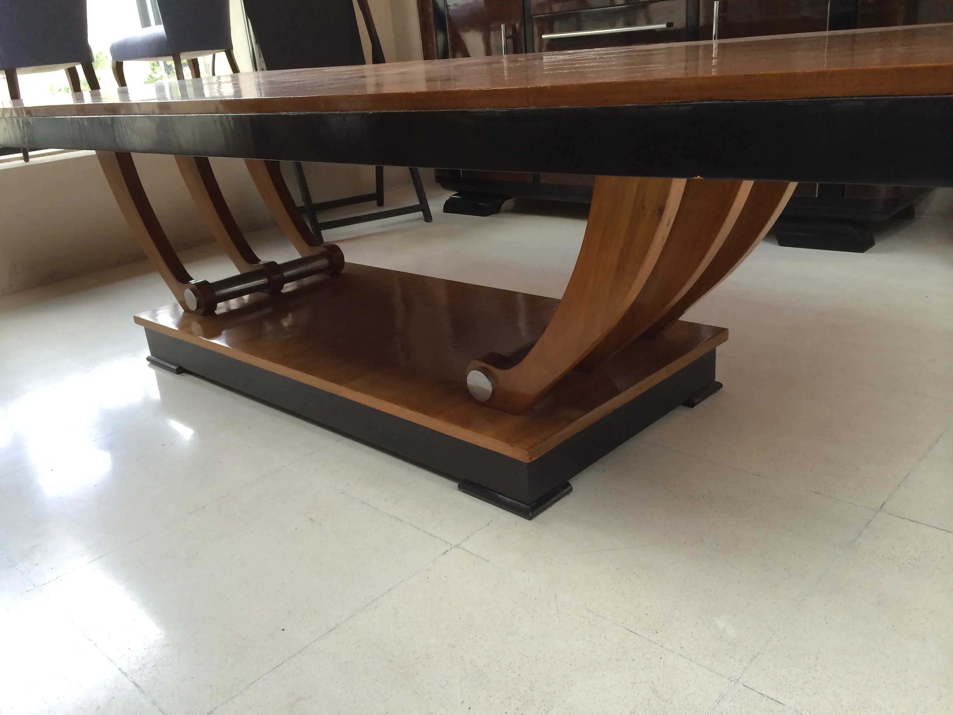 Antique dining table for 12 people, featuring elegant legs and a sturdy base, sophisticated decor.