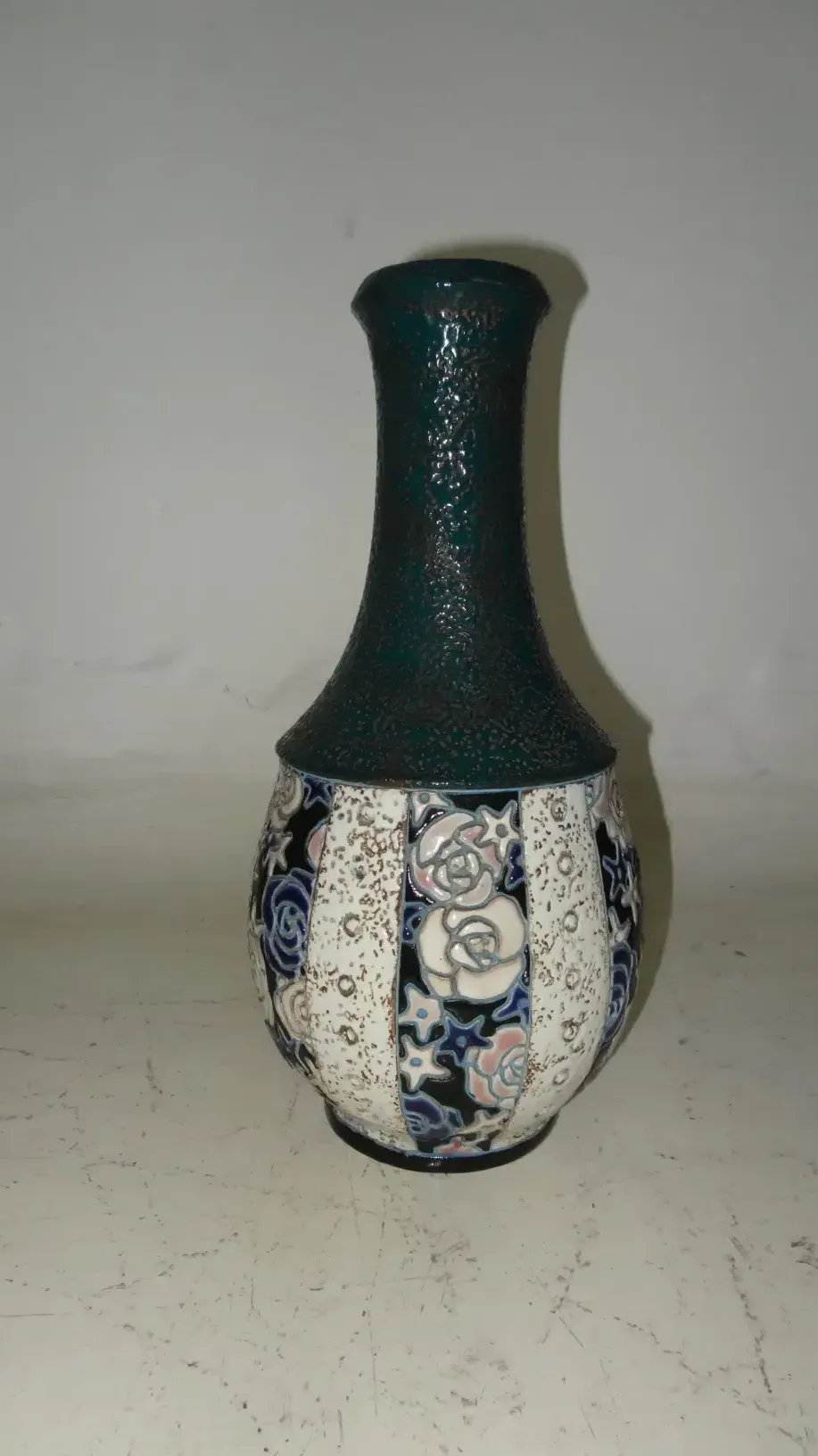 antique ceramic vase decorated with roses and intricate patterns