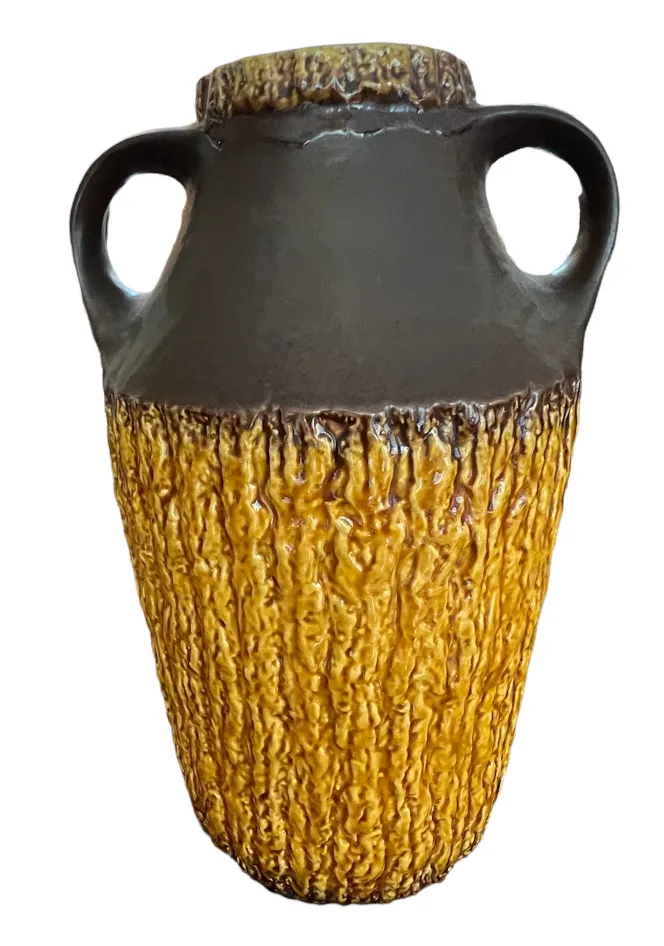 Antique ceramic vase with yellow and brown texture.